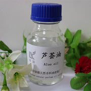 Clear bottle of Aloe base oil with blue cap surrounded by green leaves and flowers for skin hydration and nourishment
