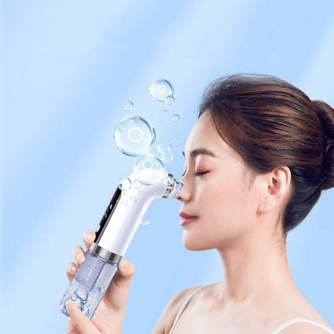 Woman using electric vacuum blackhead acne pore cleaner on face with blue background