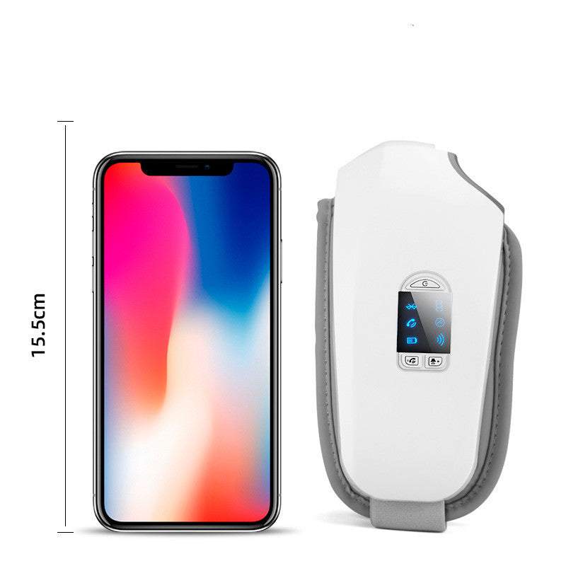 Compact white eye massager with digital display next to smartphone for size comparison, designed to reduce puffiness and eye strain.