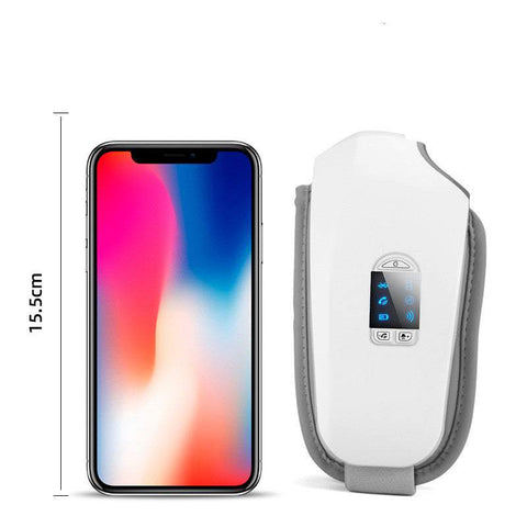 Compact white eye massager with digital display next to smartphone for size comparison, designed to reduce puffiness and eye strain.