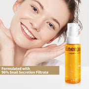 Smiling woman with glowing skin and Snail Mucin Energy Repair skincare bottle formulated with 96% snail secretion filtrate