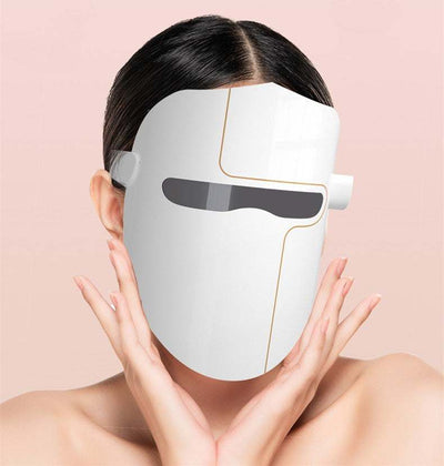 Woman wearing white LED Facial Mask Instrument for skin rejuvenation and hydration enhancement