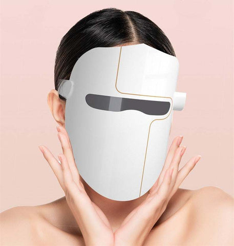 Woman wearing white LED Facial Mask Instrument for skin rejuvenation and hydration enhancement