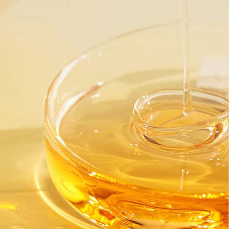 Perfume Soft Hair Care essential oil poured into glass bowl for hair hydration and frizz control