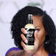 Hair Conditioner Spray bottle held by woman with curly hair improving dryness and frizz