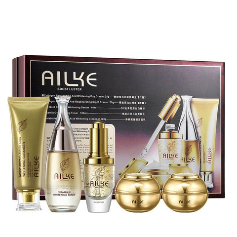 AIKLE Skin Care 5-piece Set with day and night cream, serum, toner, cleanser, and moisturizing jars in gold packaging
