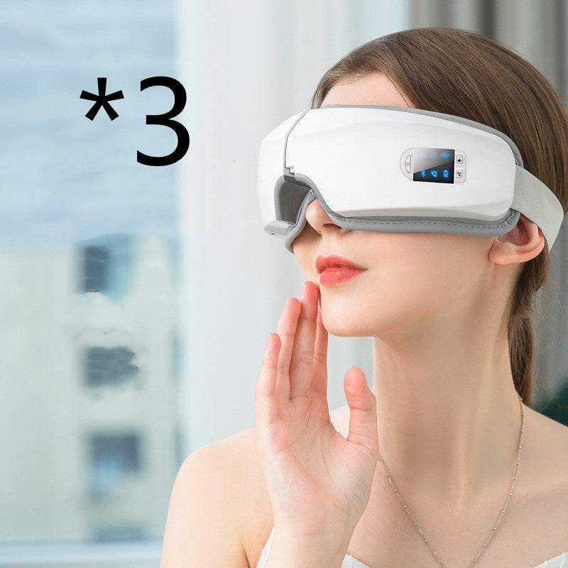 Woman using a white advanced eye massager device for relieving eye strain and reducing puffiness