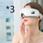 Woman using a white advanced eye massager device for relieving eye strain and reducing puffiness