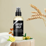 Hair Conditioner Spray bottle with natural ingredients like lemon, almonds, and wheat on a neutral background